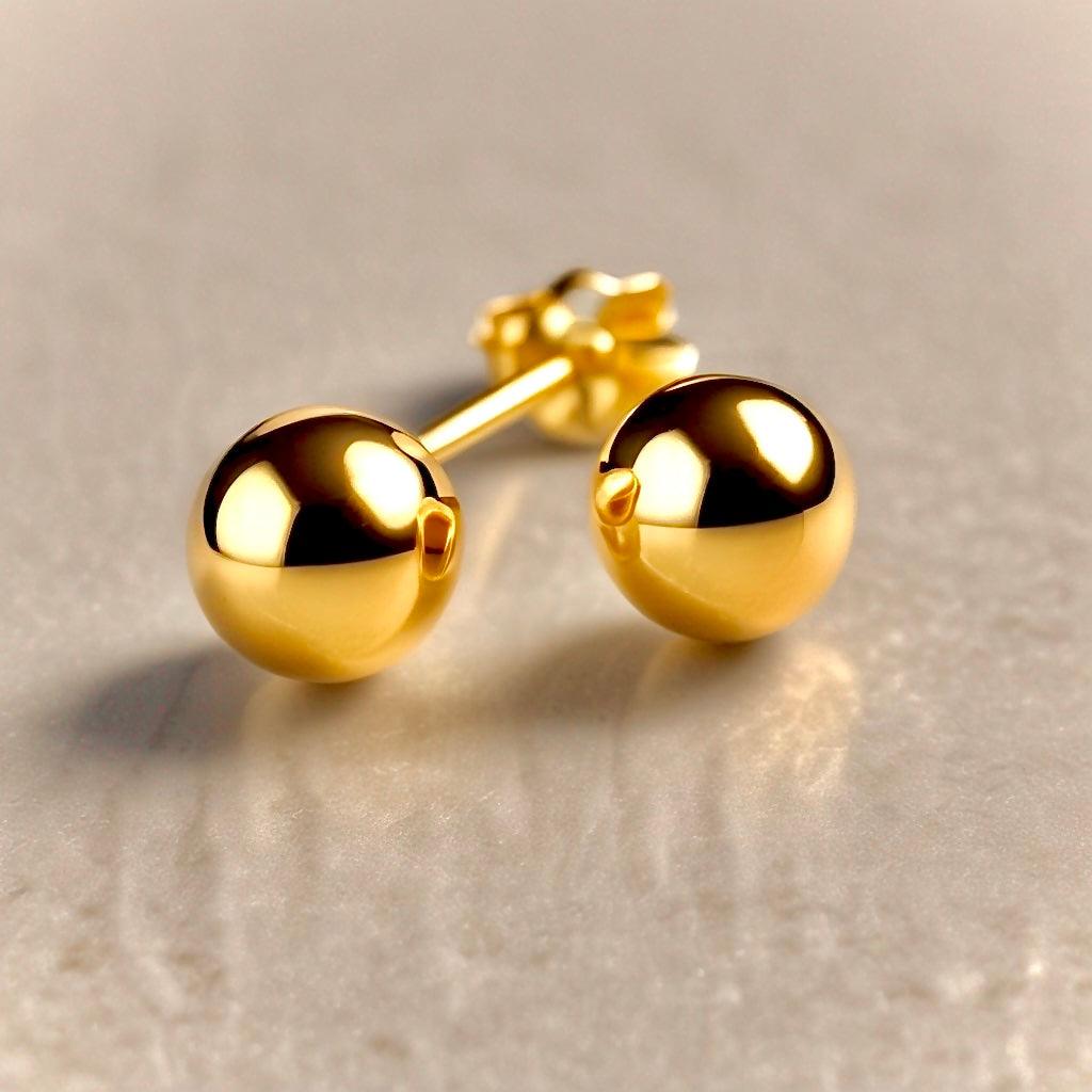 A pair of shiny yellow gold round stud earrings for women