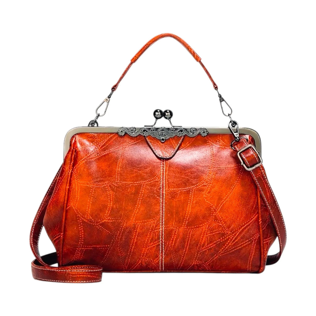 Vintage-inspired structured handbag in glossy burnt orange leather with silver metal kiss-lock frame and adjustable shoulder strap – Jewelry Bubble bags collection hero image