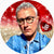 Malcolm Ross Hudson, wearing glasses and a denim jacket, with a sparkling red and gold background and a red heart featuring the initials JB. Jewelry Bubble favicon logo