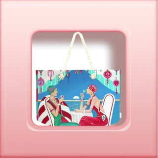 Women's tote handbag with a stylistic print of two women having a cocktail at a beach resort 