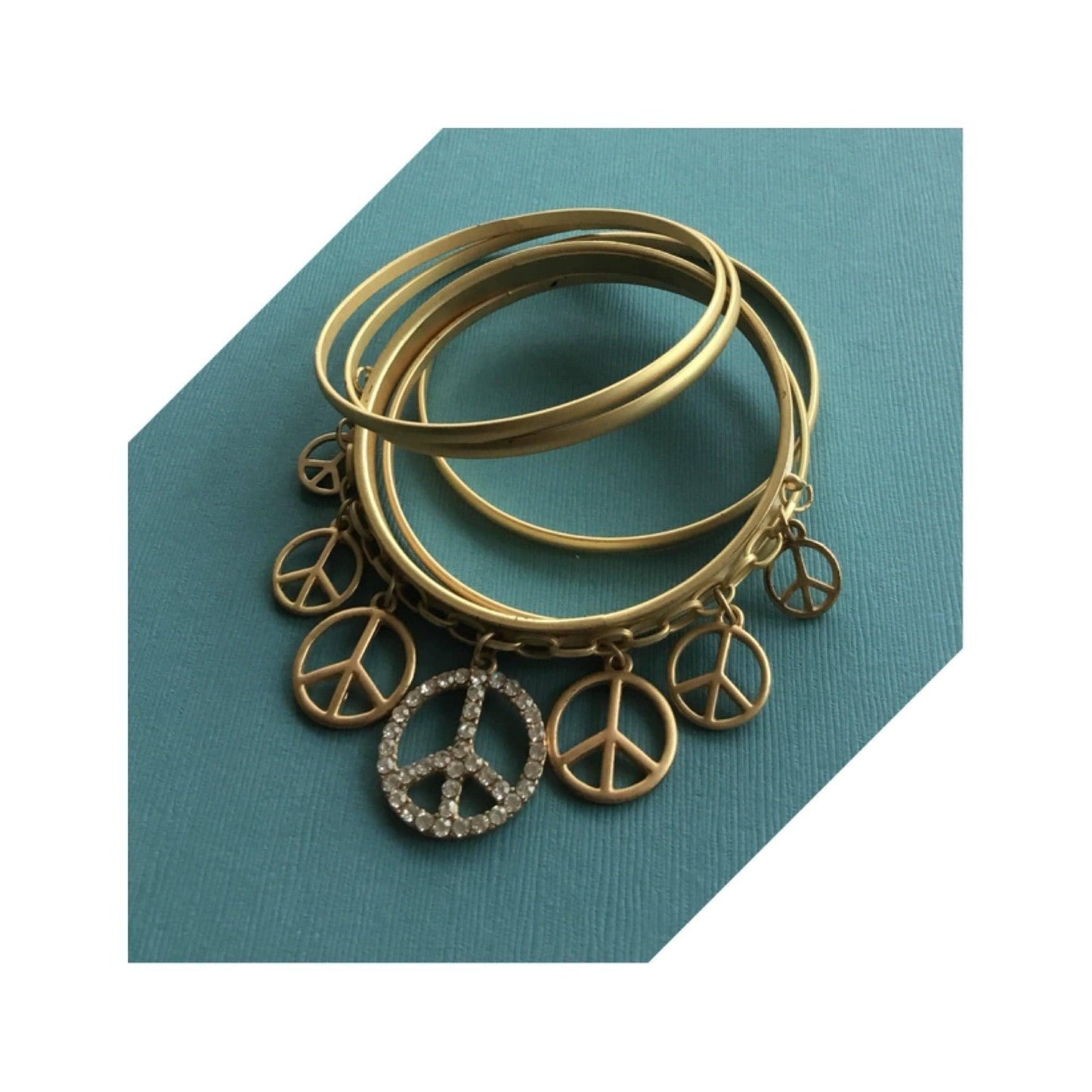 Truly eye-catching vintage stack bangles dangle peace charms