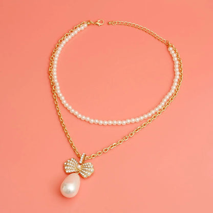 Elegant Gold Bow & Pearl Drop Pendant Necklace: Timeless Elegance for Every Occasion Jewelry Bubble